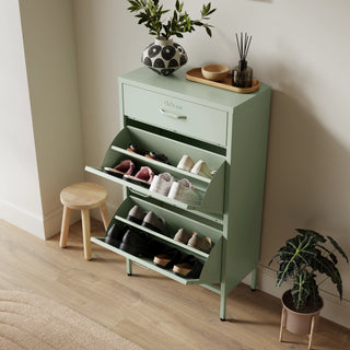 The Shoreditch shoe cabinet in sage with a top drawer, two lower shoe compartments and matching handles, styled in a hallway.