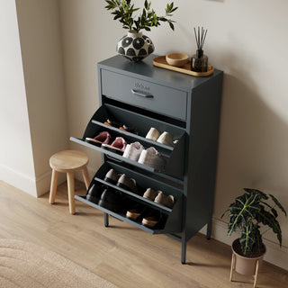 The Shoreditch shoe cabinet in grey with a top drawer, two lower shoe compartments and matching handles, styled in a hallway.